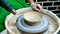 A raw clay pot in the hands of a potter. Workshop in the pottery workshop