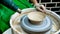 A raw clay pot in the hands of a potter. Workshop in the pottery workshop