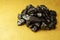 Raw coal nuggets on golden cloth background