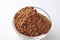 Raw cocoa Theobroma cacao powder in a glass bowl,