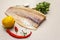 Raw cod loin fillet with lemon, sea salt, chili and cayenne pepper, parsley