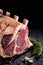 Raw cote de boeuf ribs over black background