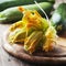 Raw courgette flower on the wooden table