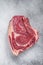 Raw cowboy steak or rib eye on the bone. Marble beef. Gray background. Top view