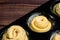 Raw cruffins before baking in the oven in an iron mold. puff pastry croissant similar to a muffin rolled into a roll. modern