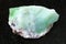 raw crystal of Chrysoprase gemstone on dark