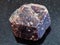 raw crystal of dravite tourmaline gemstone on dark