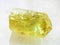 Raw crystal of yellow Apatite gemstone on white