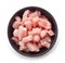 Raw cut meat chunks in black bowl, from above