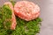 Raw cutlet for hamburger in chopped dill.