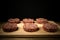 Raw cutlet of minced meat on a wooden cutting board on black background. Toned