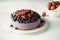 Raw dessert. Berry vegan cheesecake without baking. Dessert with fresh berries on a white plate.