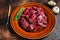 Raw diced deer steak for a venison goulash. Dark background. Top view