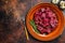 Raw diced deer steak for a venison goulash. Dark background. Top view. Copy space