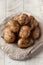 Raw dirty potatoes on a light wooden background. vegetables and harvesting.