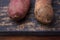 Raw dirty sweet potatoes, yam on wooden rustic brown table. Farm harvest, organic vegetables, shop local, delecious tasty vegan