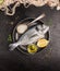 Raw dorado fish in gray rustic plate with lemon,oil and spoon of salt on dark stone background