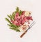 Raw Double lamb loin chops with meat fork herb and spices on white wooden background