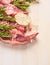 Raw double lamb loin chops meat with ingredients for cooking on white wooden background