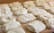 Raw dough divided into portioned pieces on baker worktable