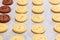 Raw dough. Yellow and brown cookies buttons