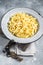 Raw dried spaetzle egg noodle. Gray background. Top view