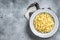 Raw dried spaetzle egg noodle. Gray background. Top view. Copy space