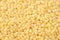 Raw dried uncooked millet seeds heap macro