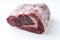 Raw dry aged angus entrecote beef steak and roast offered as close-up on white background