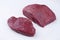 Raw dry aged bison beef rump steak slices on white background - free-form select