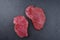 Raw dry aged bison beef rump steaks on black background