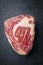 Raw dry aged Black Angus Entrecote Steak  on ablack board