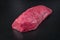 Raw dry aged wagyu beef rump fillet steak piece on black background