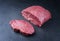 Raw dry aged wagyu beef rump steak slice and piece on black background
