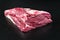 Raw dry aged wagyu beef shoulder clod roast on black background