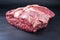 Raw dry aged wagyu beef shoulder clod roast on black background