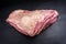 Raw dry aged wagyu beef shoulder clod roast on black background