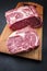 Raw dry aged wagyu entrecote beef steak roast on a modern design wooden board