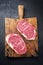 Raw dry aged wagyu entrecote beef steak roast on a rustic wooden cutting board