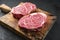 Raw dry aged wagyu entrecote beef steak roast on a rustic wooden cutting board