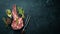 Raw dry steak tomahawk on a black background. Steak Cowboy. Barbecue. Top view.