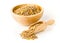 Raw, dry, uncooked brown lentil legumes in wood bowl and wooden scoop over white background