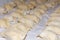 Raw dumplings lying on a white fabric background