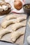 Raw dumplings (varenyky) with tasty filling on grey table, closeup. Traditional Ukrainian dish