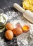 Raw egg yolk with flour, raw homemade fettucine and rolling pin