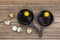 Raw eggs in frying pan, quail eggs on wooden background