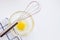 Raw eggs yolk on glass bowl and whisk. Whisk over fresh raw chicken yolks