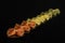 Raw farfalle tricolore isolated on black glass