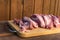 Raw fat cuting pieces of pork on wooden background. Piece of fresh boneless pork, neck part or collar. Big piece of red raw meat o