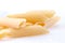 Raw feathers macaroni. Italian pasta close up on the white background